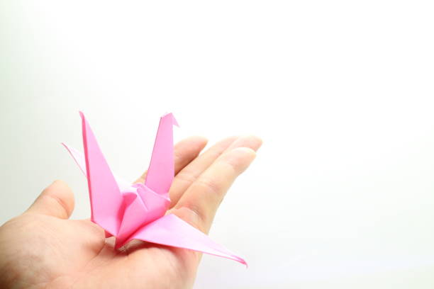 istock A cute paper crane on your hand 1319929500