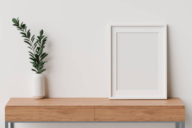 istock Minimal interior design with mock-up frame an plant vase on wooden table with white wall, 3D rendering 1319929650