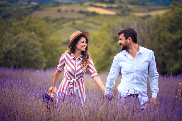 istock Young couple having fun on lavender field. 1319929880