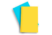 Colored blank books on top of each other over white background.