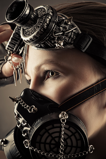 woman face profile in steampunk mask cut out on gray background