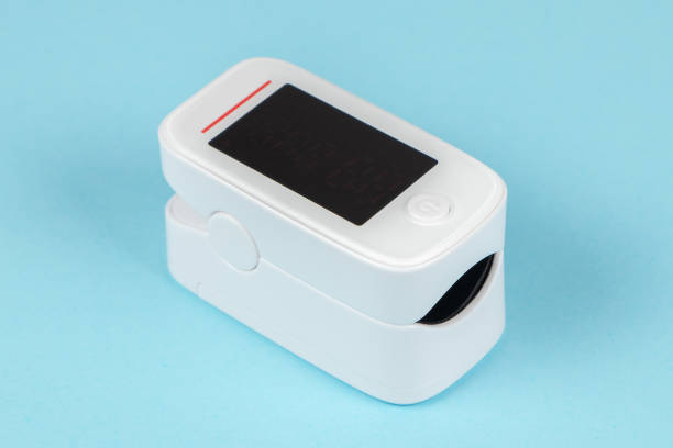istock Modern fingertip pulse oximeter isolated on blue background 1319936761