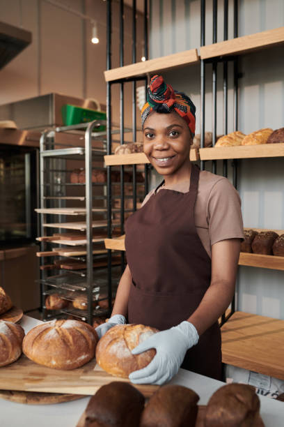istock Smiling owner in uniform in the bakery 1319936851