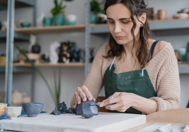 istock Female ceramist working in her studio. Looking at camera 1319936936