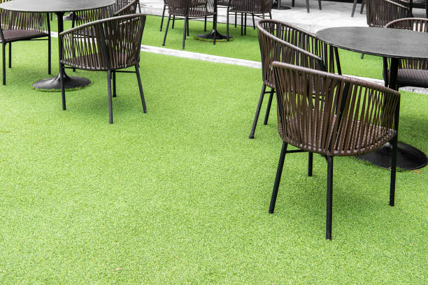 outdoor table set. Placed on an artificial green grass, table set for dining decorating with artificial grass circle shape on the floor.