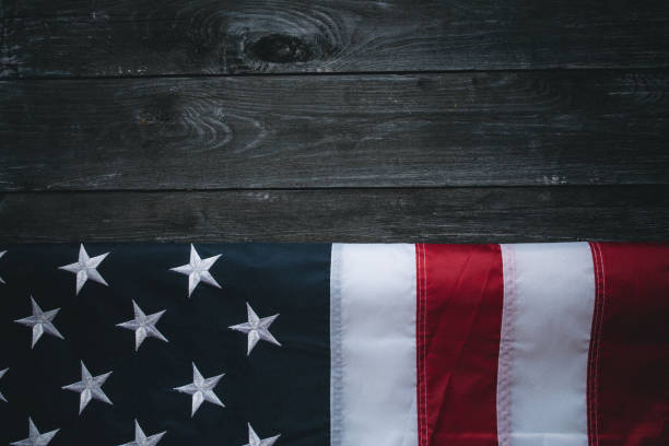 istock USA Flag on dark wooden background 1319936990