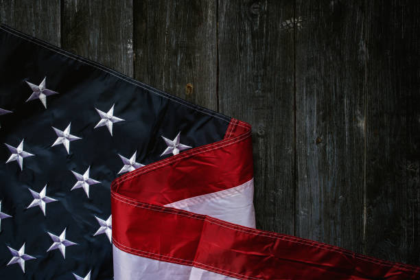 istock USA Flag on dark wooden background 1319937302