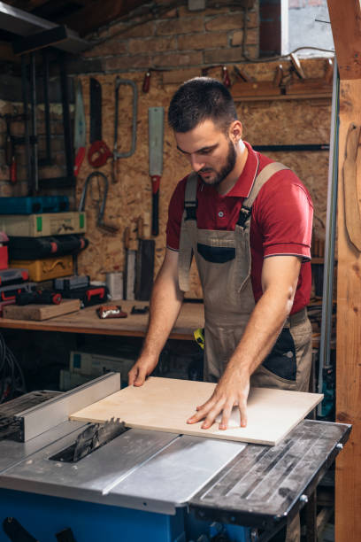 istock Handsome Carpenter Making Furniture in his Workshop 1319938027