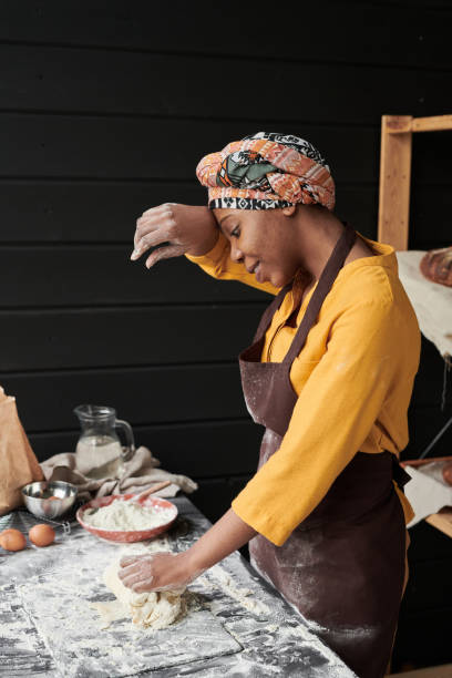 istock African woman cooking in the kitchen 1319938371
