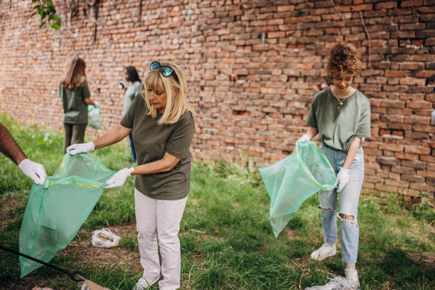 istock Group of volunteers cleaning park 1319938735