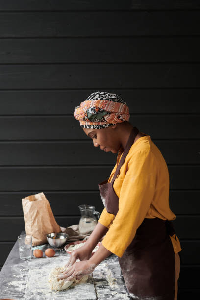 istock Woman kneading the dough for bread 1319939400