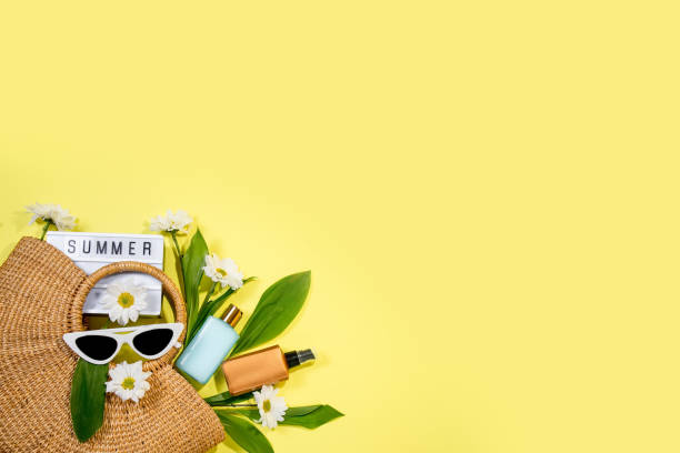 istock beach bag with beach accessories on a colored background top view. Sunscreen, glasses 1319939571