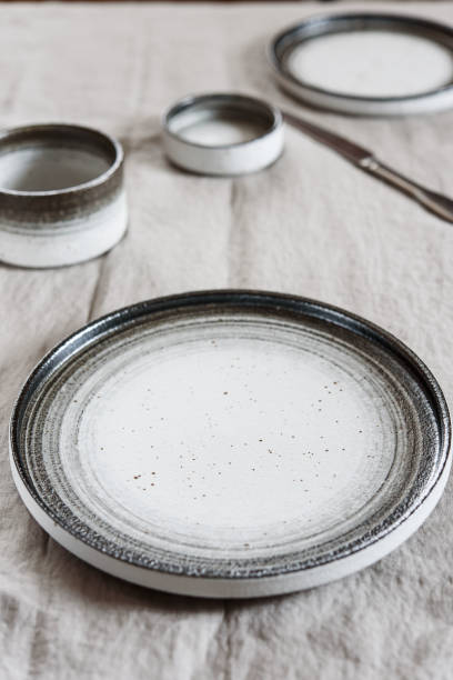 istock Empty pottery plate, sauceboats and cutlery on light background 1319939675