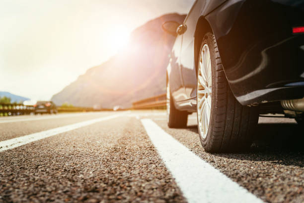 Car is standing on the breakdown lane, asphalt and tyre, Italy Close up of a car standing on a breakdown lane, summer vacation car wheel stock pictures, royalty-free photos & images