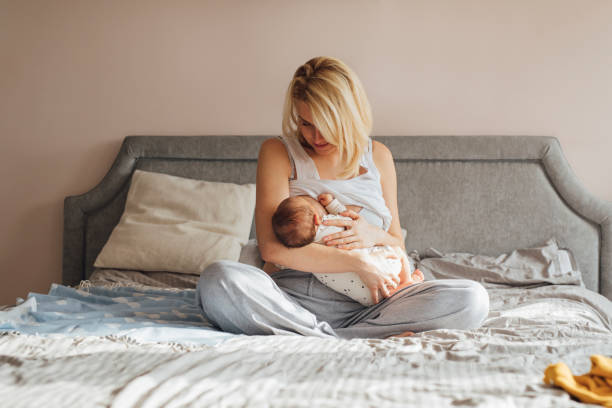 istock Bonding With Newborn: Mother Is Breastfeeding On Bed 1319940119