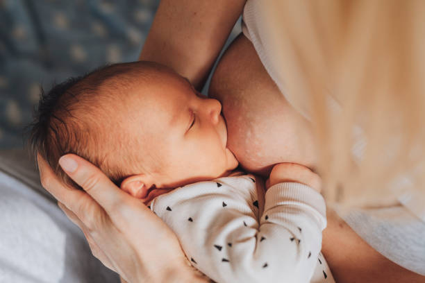 istock Bonding With Newborn: Mother Is Breastfeeding On Bad 1319940126