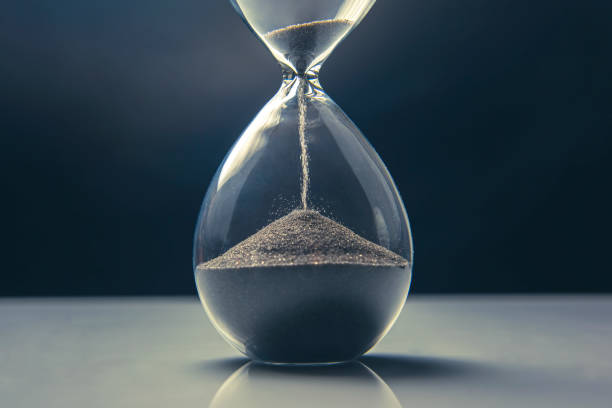 istock Hourglass on a light background. Time is money. Business solutions in time. 1319941119