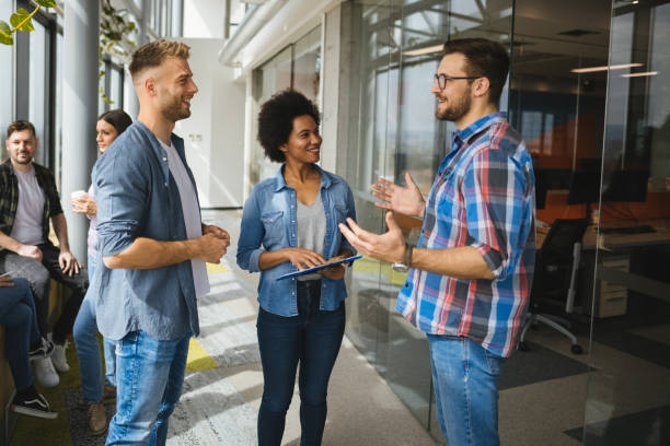 istock A group of web designers chatting in office hallway 1319942261