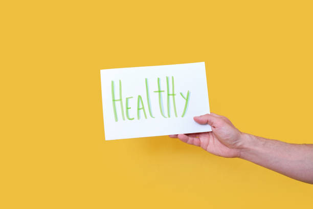 istock hand showing white cardboard with handwritten text HEALTHY 1319942466