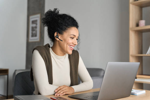 istock African American female student having video call videoconference on laptop. 1319942594