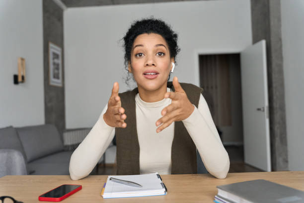 istock African American female teacher having video call videoconference on laptop. 1319942595