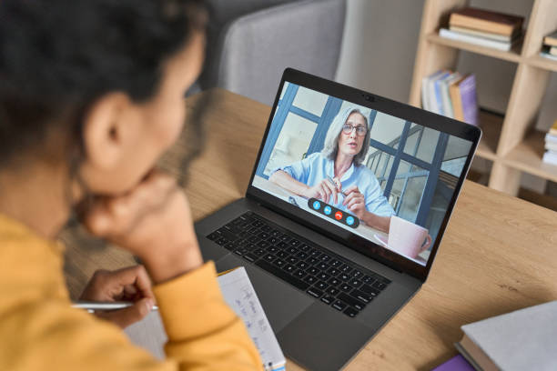 istock African American female student having video educational class on laptop. 1319942605