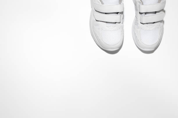 istock mock up flat lay two white women's sneakers with velcro fasteners with copy space isolated on a white background 1319943824