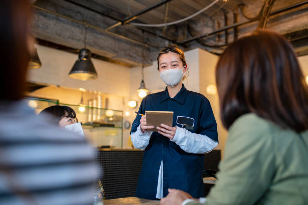 istock Waitress wearing a face mask taking an order in a pizzeria 1319943885
