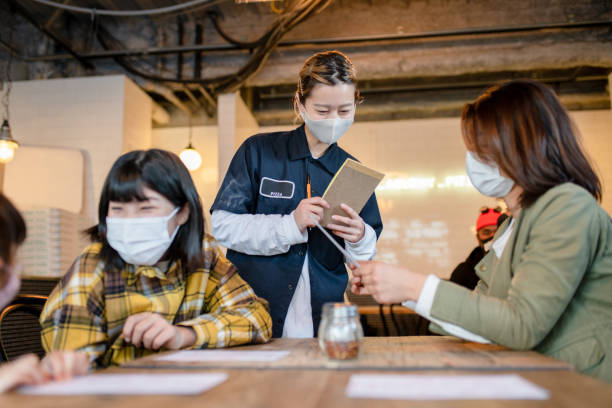 istock Waitress wearing a face mask taking an order in a pizzeria 1319943909
