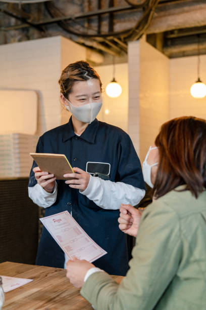 istock Waitress wearing a face mask taking an order in a pizzeria 1319943916