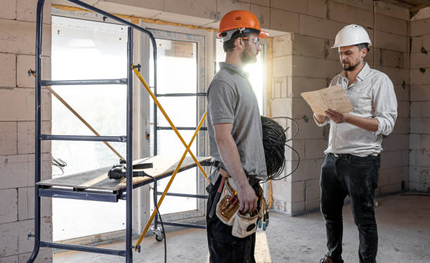 istock Two builders collaborate to build a new home. 1319944128