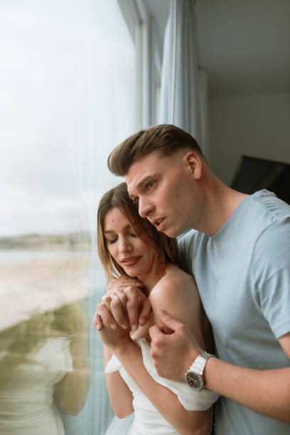 istock Young couple looking through the window 1319945118