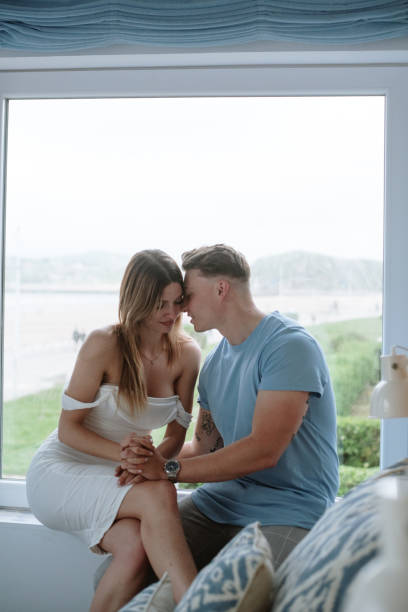 istock Young couple sitting by a window 1319945253