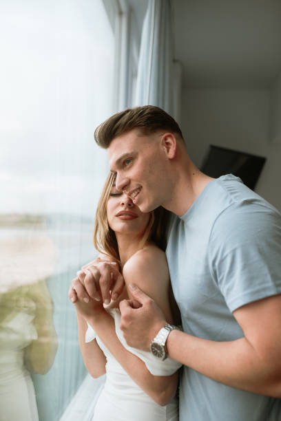 istock Young couple looking through the window 1319945325