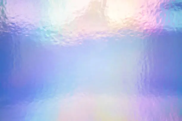 Photo of An iridescent holographic foil background pastel colors