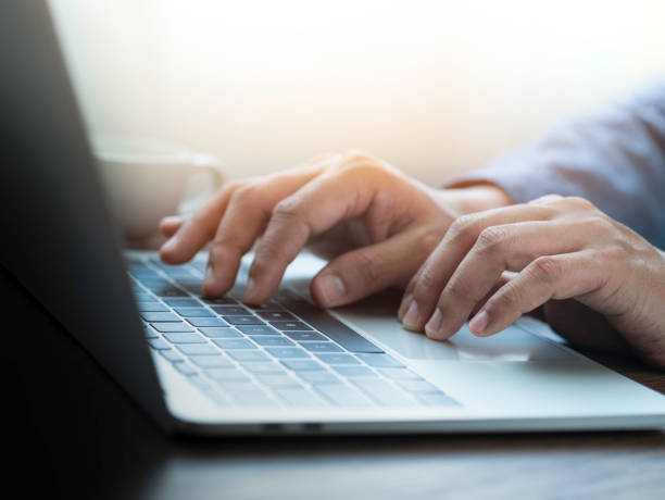 istock Close-up of man hands using and typing keyboard of laptop computer on office desk. Workspace, businessman working project creative idea for job online network. Business finance and technology concept. 1319947524