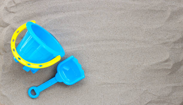 istock Plastic toys, shovel and bucket on sand 1319947892