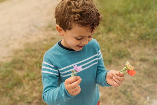 Boy showing handpicked flowers