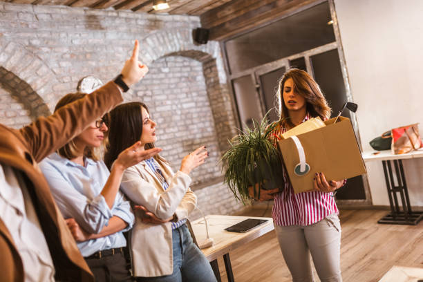istock Fired woman with personal stuff in office 1319947912
