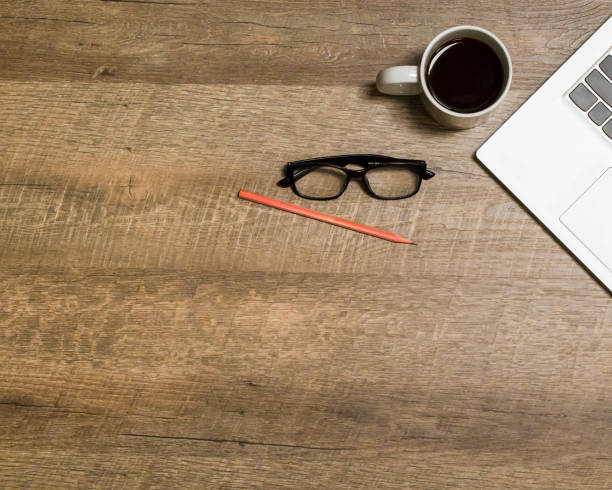 istock Notebook, coffee cup, glasses, pencil, on a wooden background. 1319948810