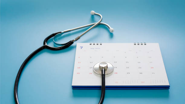 istock Stethoscope with date on calendar page on wooden table medical concept 1319948830