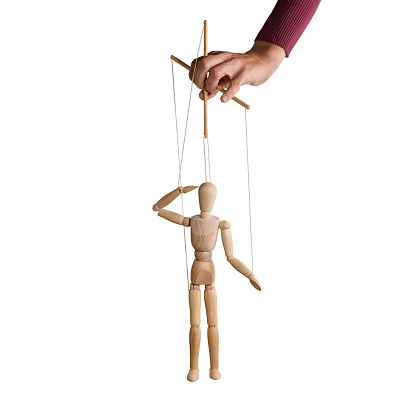 The human hand with marionette on the strings.