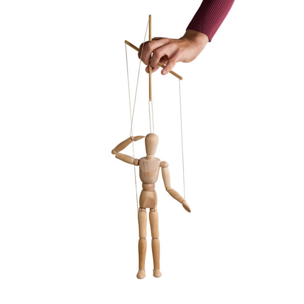 The human hand with marionette on the strings. The human hand with marionette on the strings. Concept of control. On white. puppet stock pictures, royalty-free photos & images