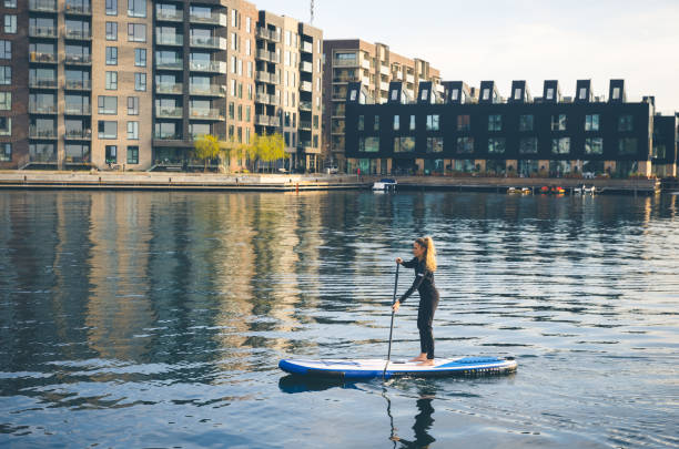 Female SUP paddle-boarding in ocean