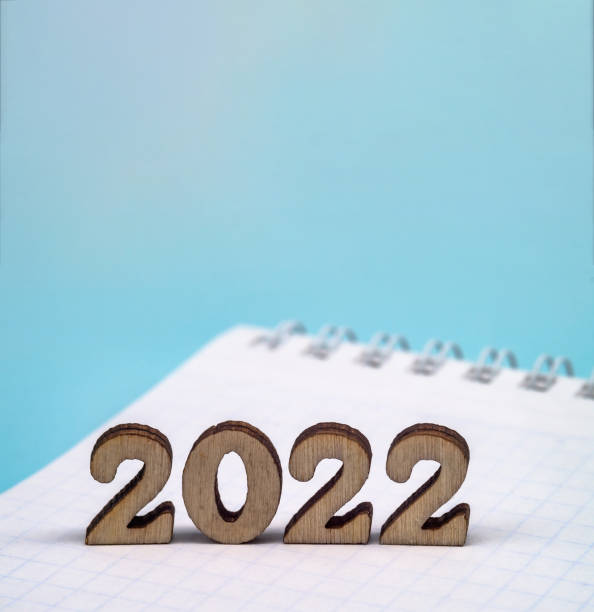 istock Figures 2022 on blue background. Banner 2022 and notepad. 1319951356