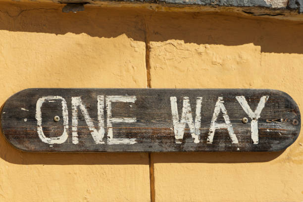 Wooden sign on the wall that says 'one way'