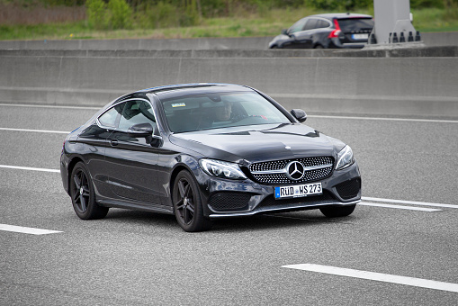 Diedenbergen, Germany - May 06, 2021: Mercedes-Benz E-class Coupe (C238) on a highway nearby Wiesbaden, Germany. The E-Class-cars are executive cars and were launched in 2016. Mercedes-Benz is a German manufacturer of automobiles and trucks and a division of Daimler AG, formerly Daimler-Chrysler