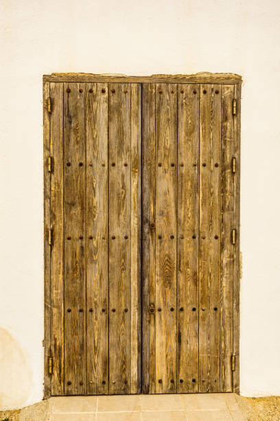 istock Old wooden door with rusty screws 1319951813