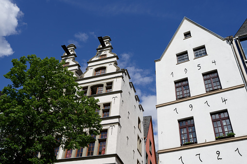 historical medieval houses in the old town of cologne against blue sky