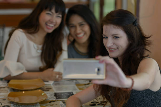 istock Cheerful Women Doing Selfie While Sitting At Home 1319955787